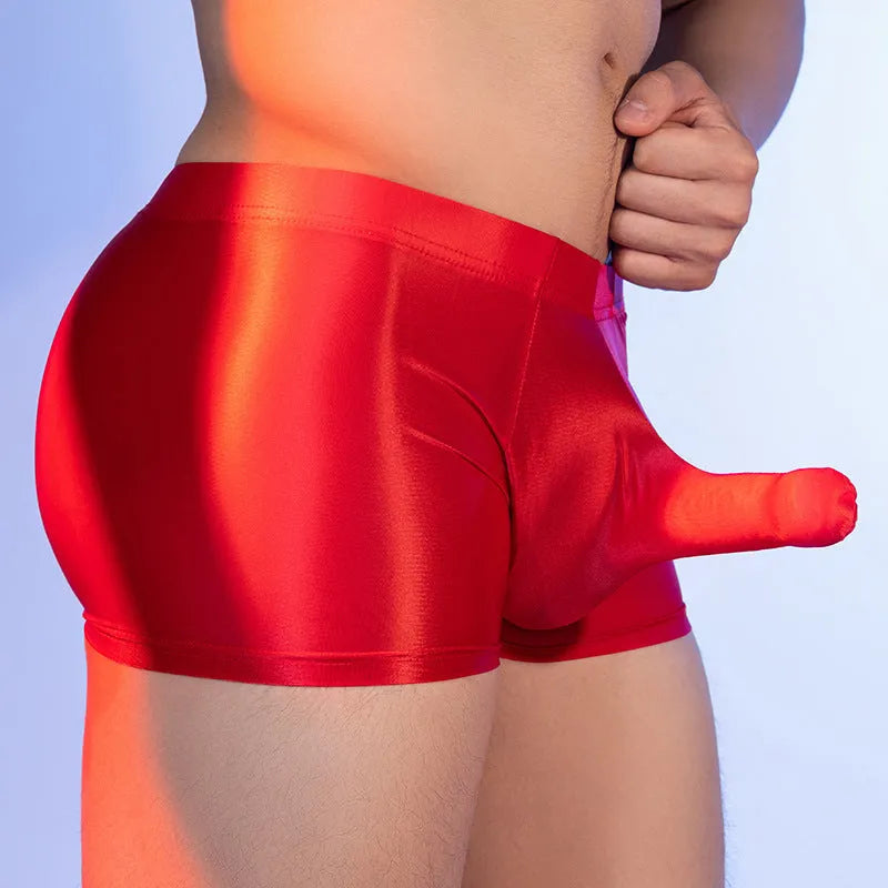 Men's red boxer shorts with a black elephant nose novelty print, showing mid-waist and seamless design.
