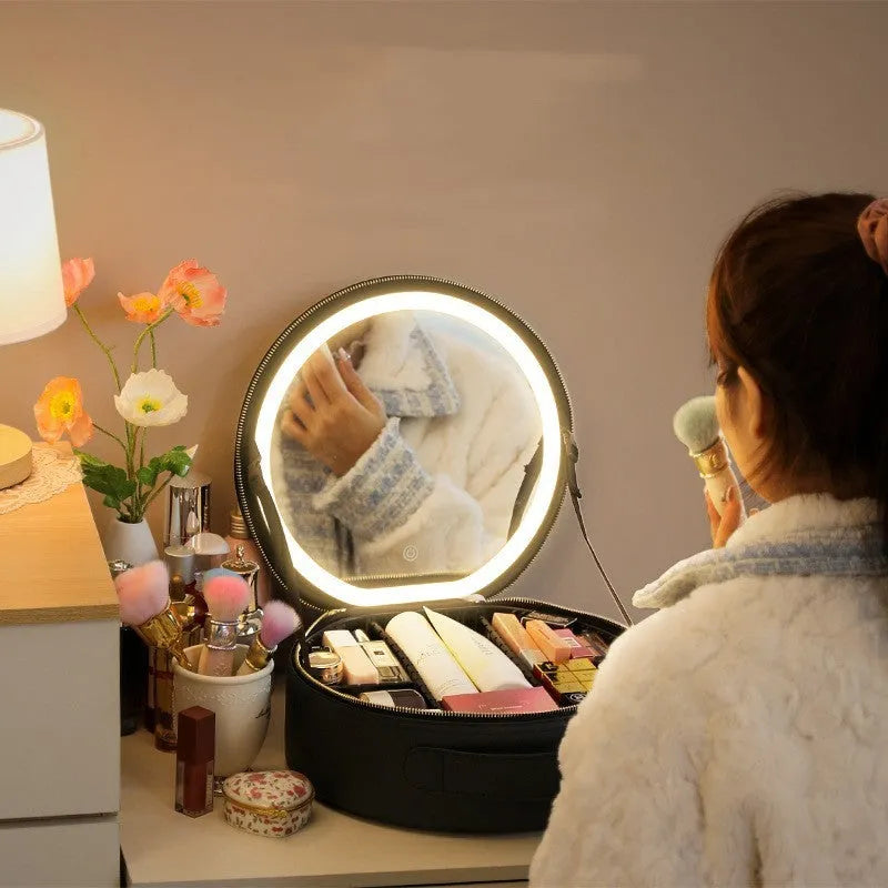 Round pink PU leather makeup bag with built-in LED illuminated mirror and internal cosmetic partitions open.