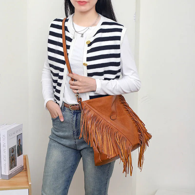 Large capacity soft PU messenger bag with rivet detailing, sandwich pocket, and long shoulder strap in brown colour