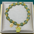 Peace buckle bracelet with a coloured glass rabbit charm on a simple band