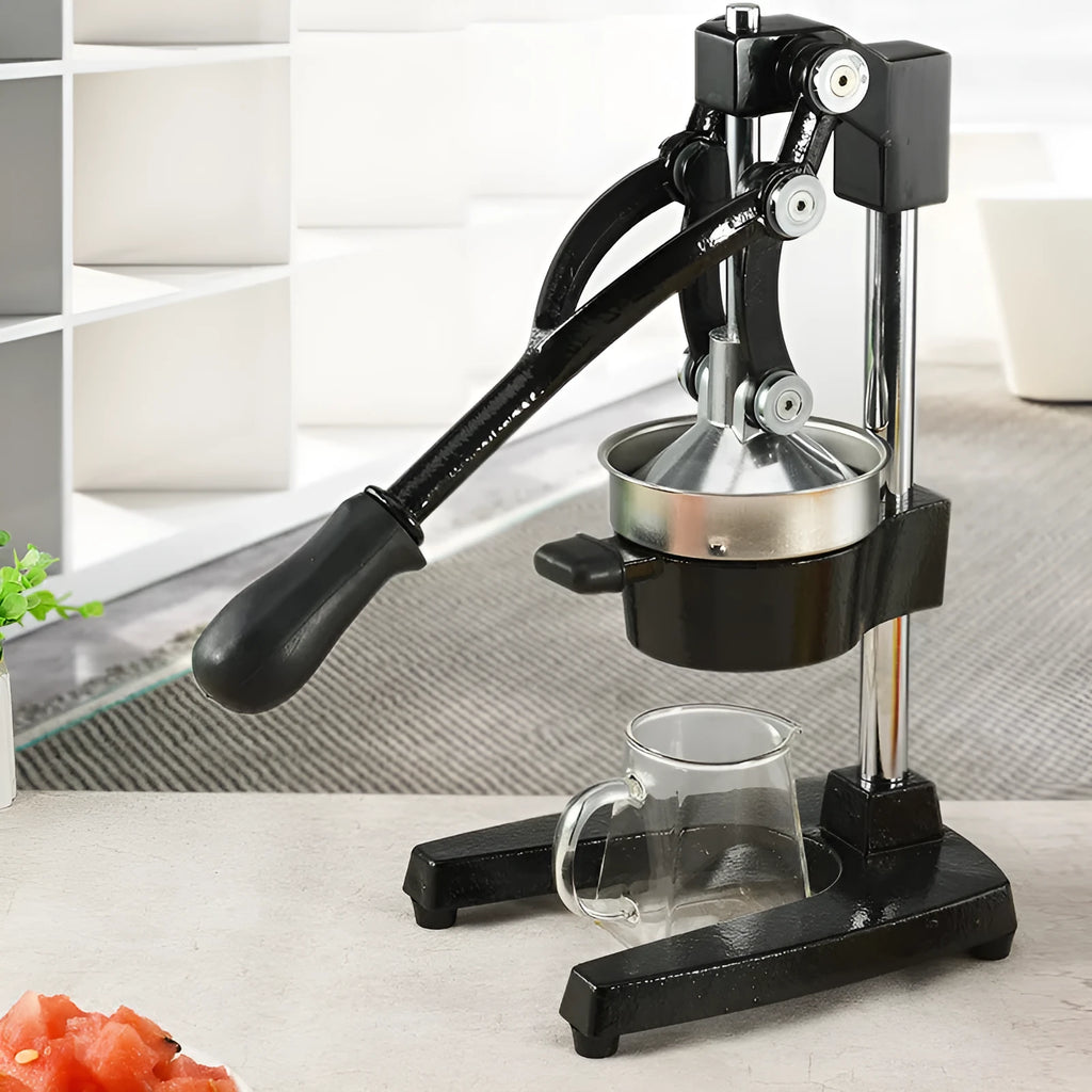 Black and white manual cast iron citrus juicer with stainless steel funnel, 40cm tall.