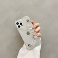 Transparent clear iPhone case with a love heart chain design on a smartphone.