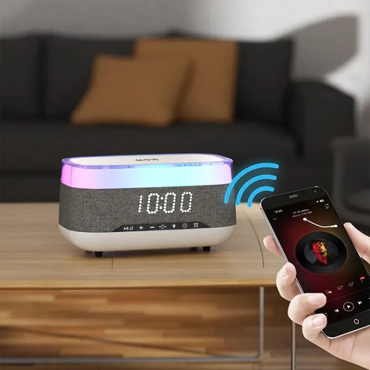 White multifunctional alarm clock with Bluetooth speaker and wireless charging pad on a bedside table.