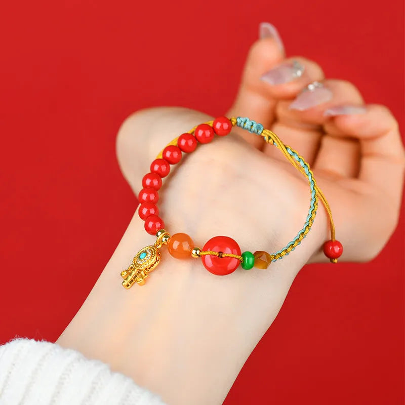 Hand-woven cinnabar peace blessing bracelet with buckle closure in emperor red sand colour