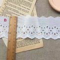 Cotton embroidered lace cutout trim roll showing four different width options for DIY clothing projects