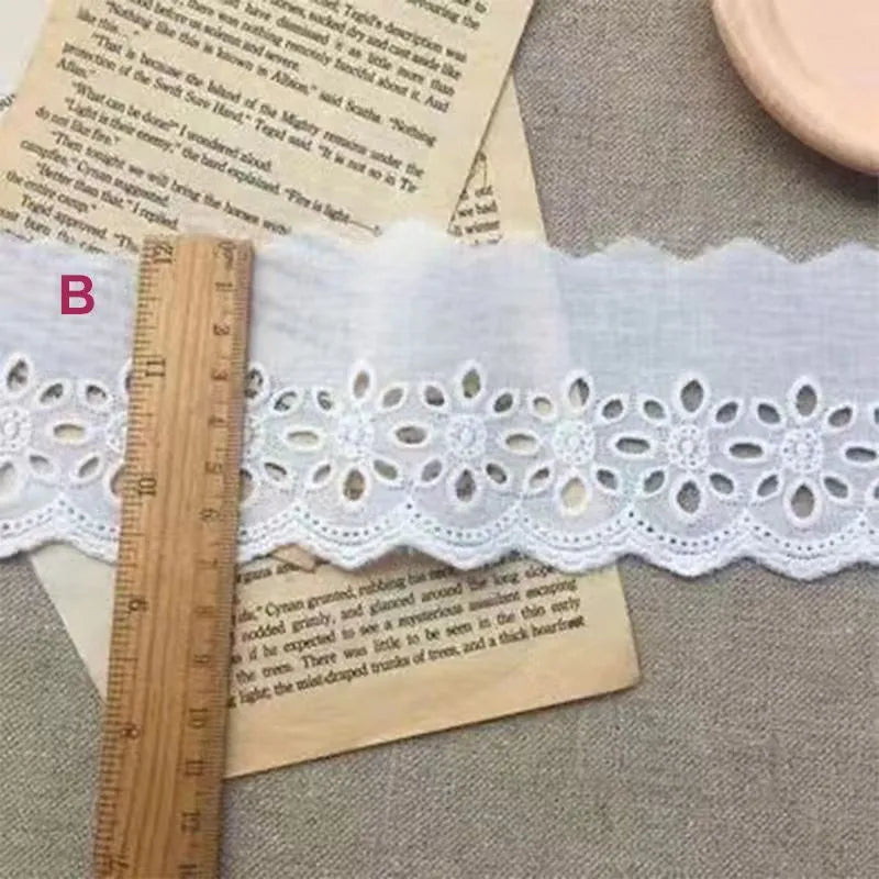Cotton embroidered lace cutout trim roll showing four different width options for DIY clothing projects