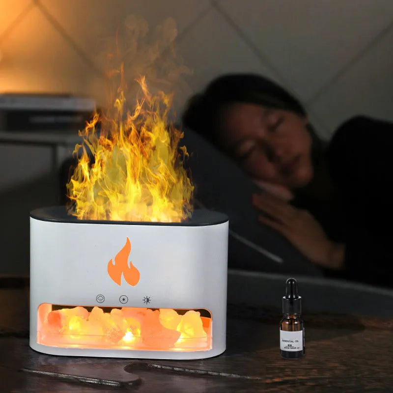 Square white ultrasonic humidifier and aromatherapy diffuser with colourful 3D flame light effect on a desk.