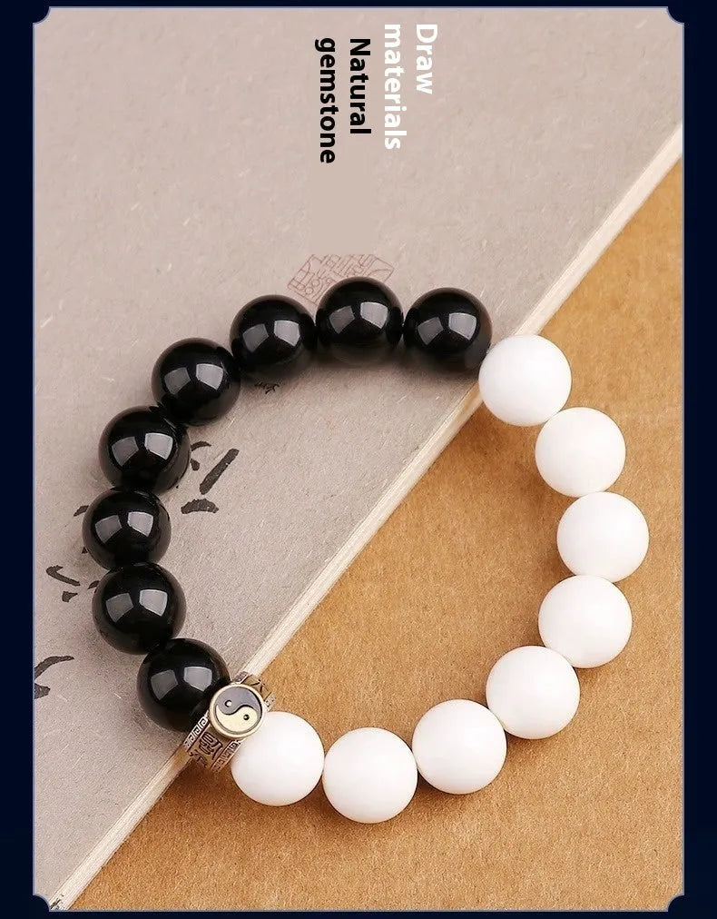 Black and white obsidian tai chi bracelet with 10mm geometric beads and bodhi mantra design