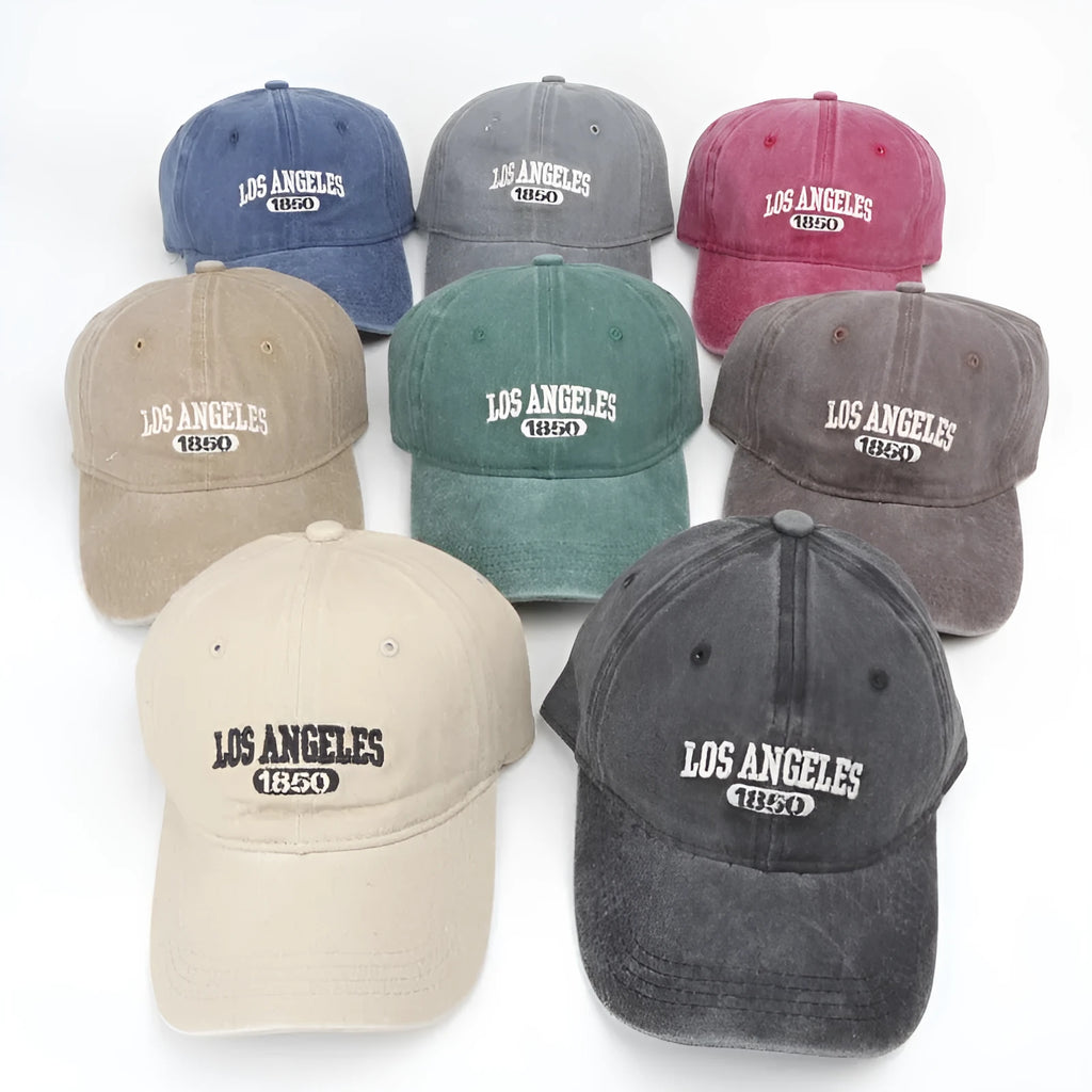 Retro style acrylic peaked cap with distressed letter embroidery on the front, shown in beige colour.