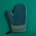 Dark blue pet hair removal glove for cats and dogs on a fabric background