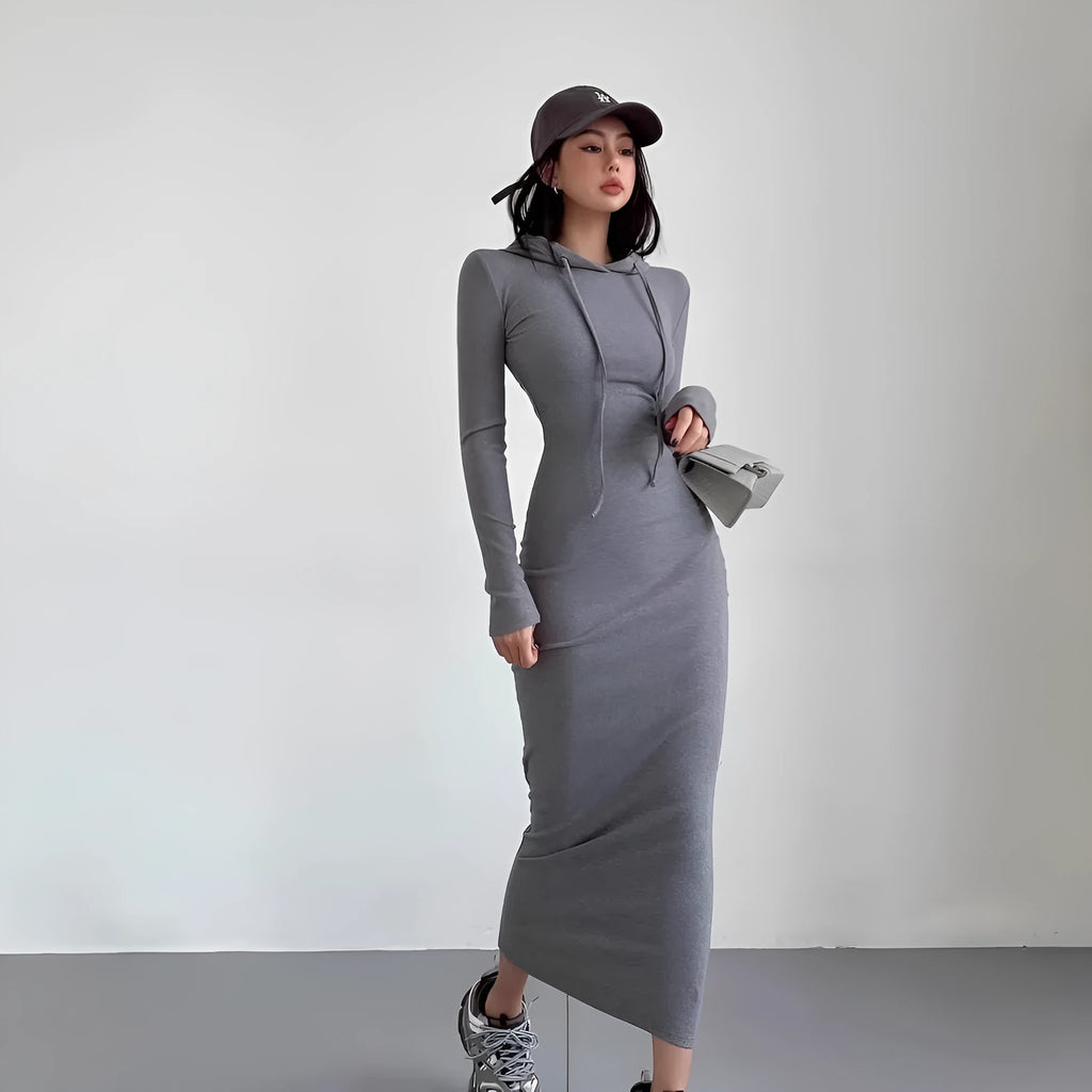A light grey women's hooded sheath dress with long sleeves and a high waist on a model.