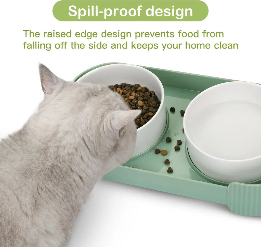Green ceramic elevated cat bowl set with two tilted dishes on a non-slip stand.