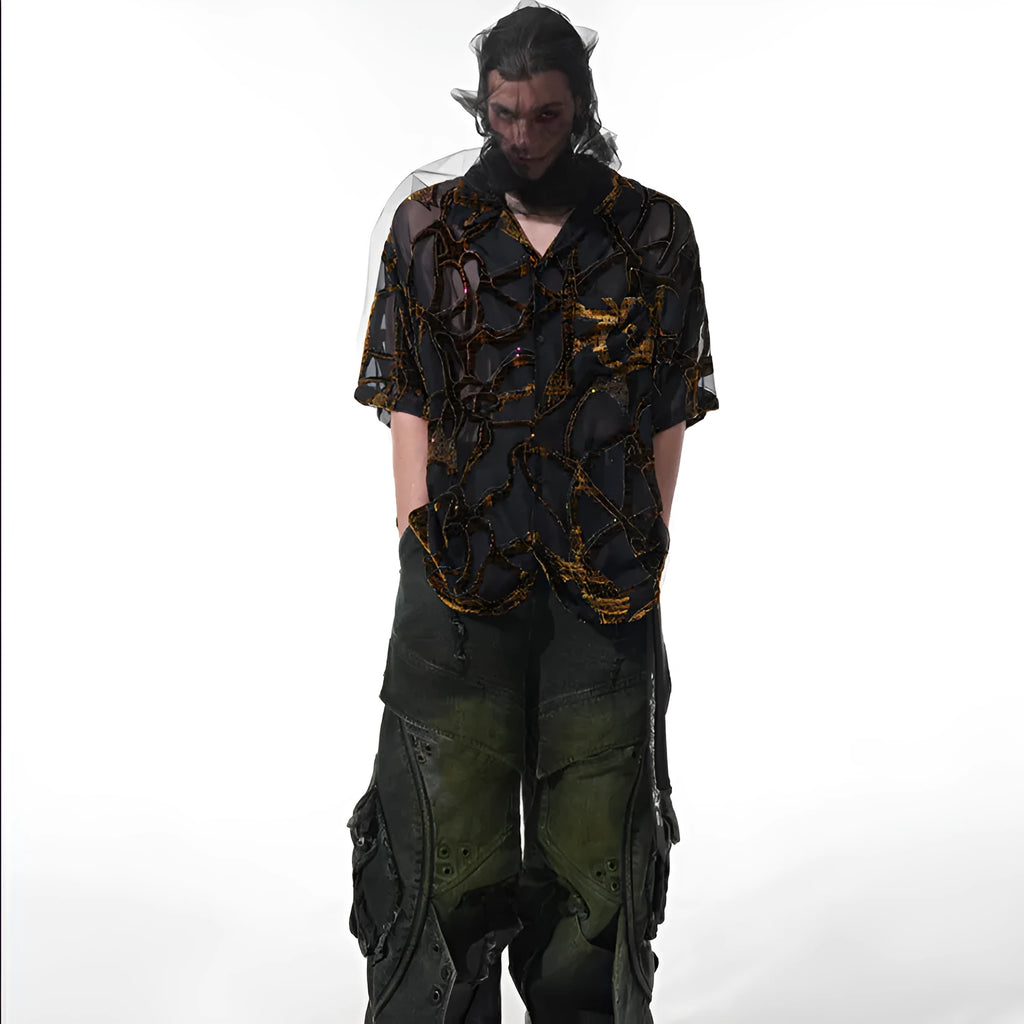 Man wearing a black and grey snake pattern short-sleeved translucent polyester shirt with a loose fit.