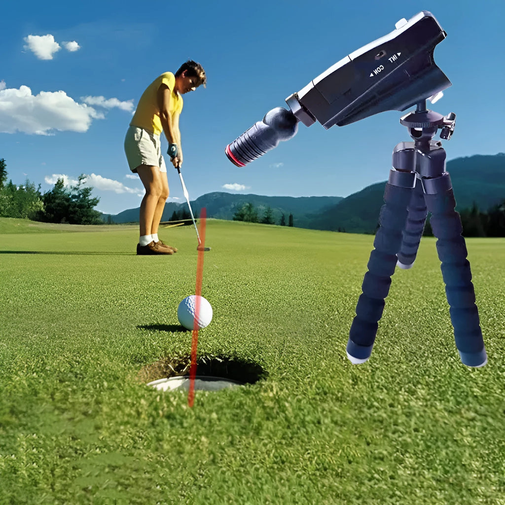 Golf putter laser aiming instrument showing laser dot alignment on a practice green.