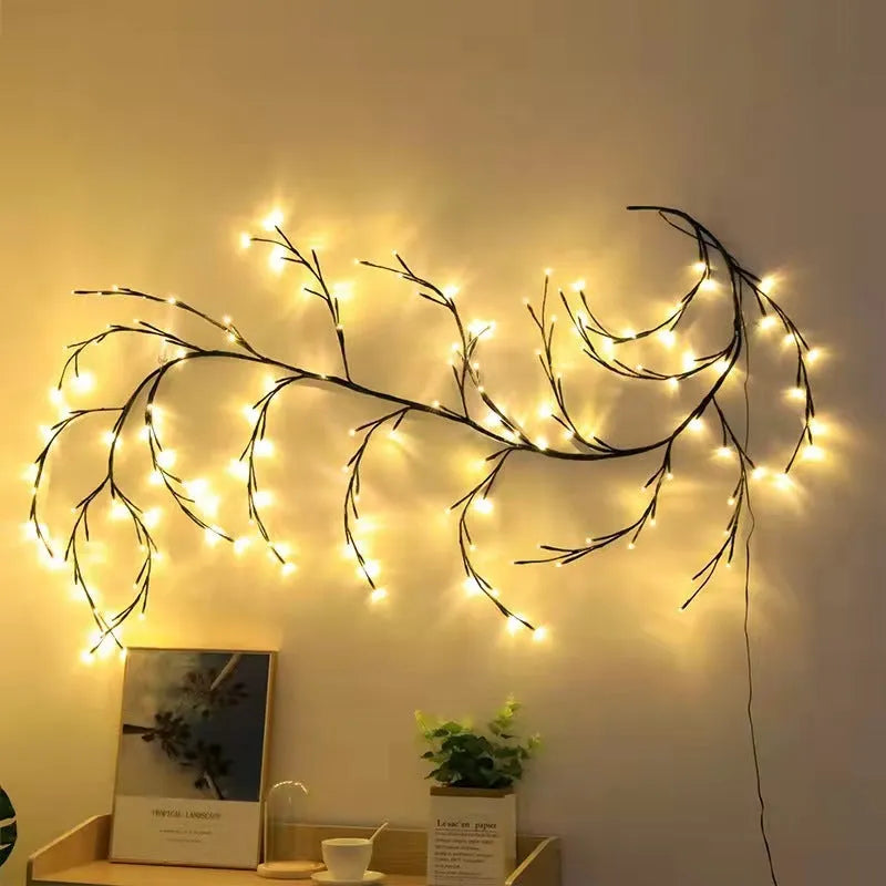 Flexible LED willow vine garland with warm white lights shaped into a decorative curve on a wall.