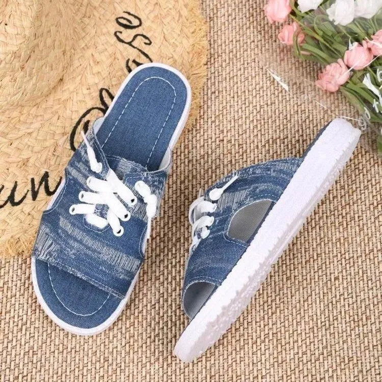 Blue women's Roman-style flat canvas slippers with a cloth upper and rubber sole.