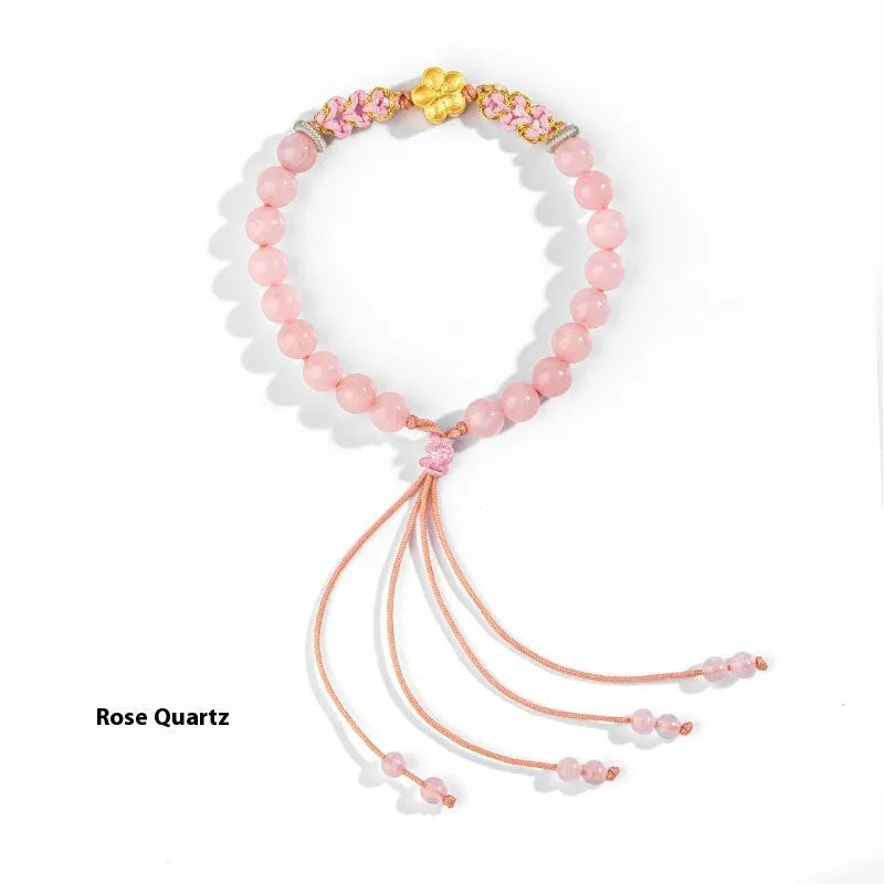 Chinese style peach blossom bracelet with hand-woven red rope strap and crystal centrepiece