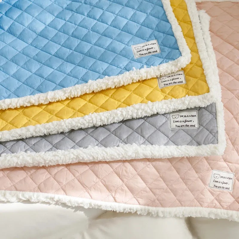 Blue quilted terry cloth pet blanket for cats showing textured surface and size scale.