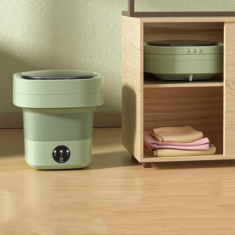 Green foldable portable mini washing machine for socks and underwear with drain pipe and basket.
