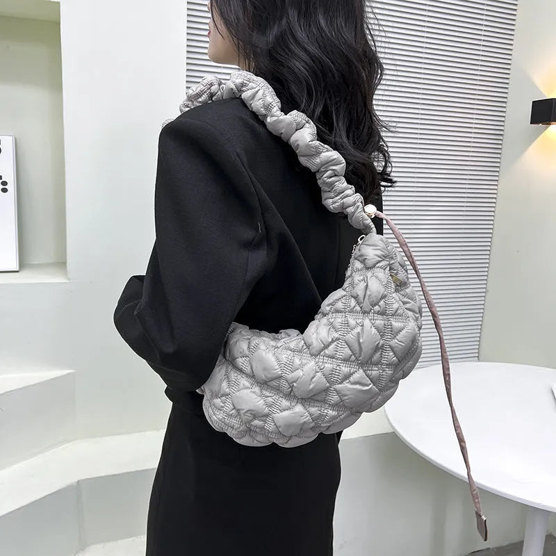 Women's nylon messenger bag in solid colour with adjustable shoulder strap, shown in beige