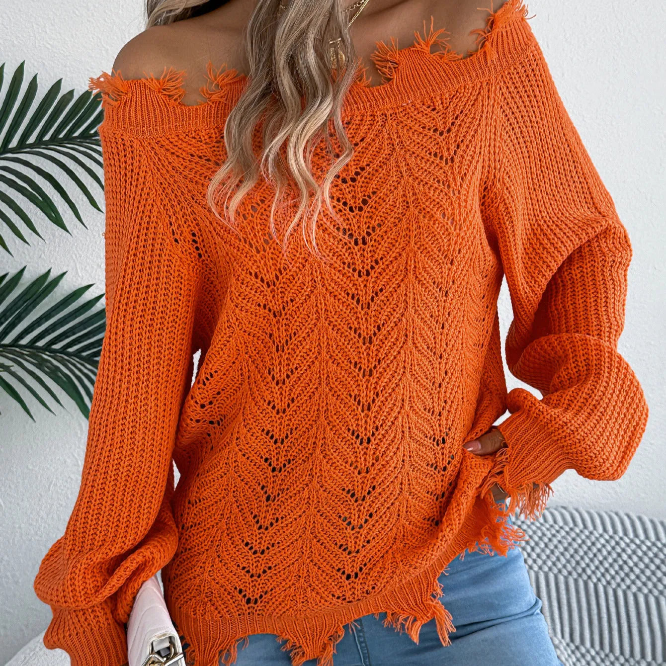 Hollow-out long-sleeved off-the-shoulder pullover sweater in artificial wool acrylic fibre available in black, orange, and white colours