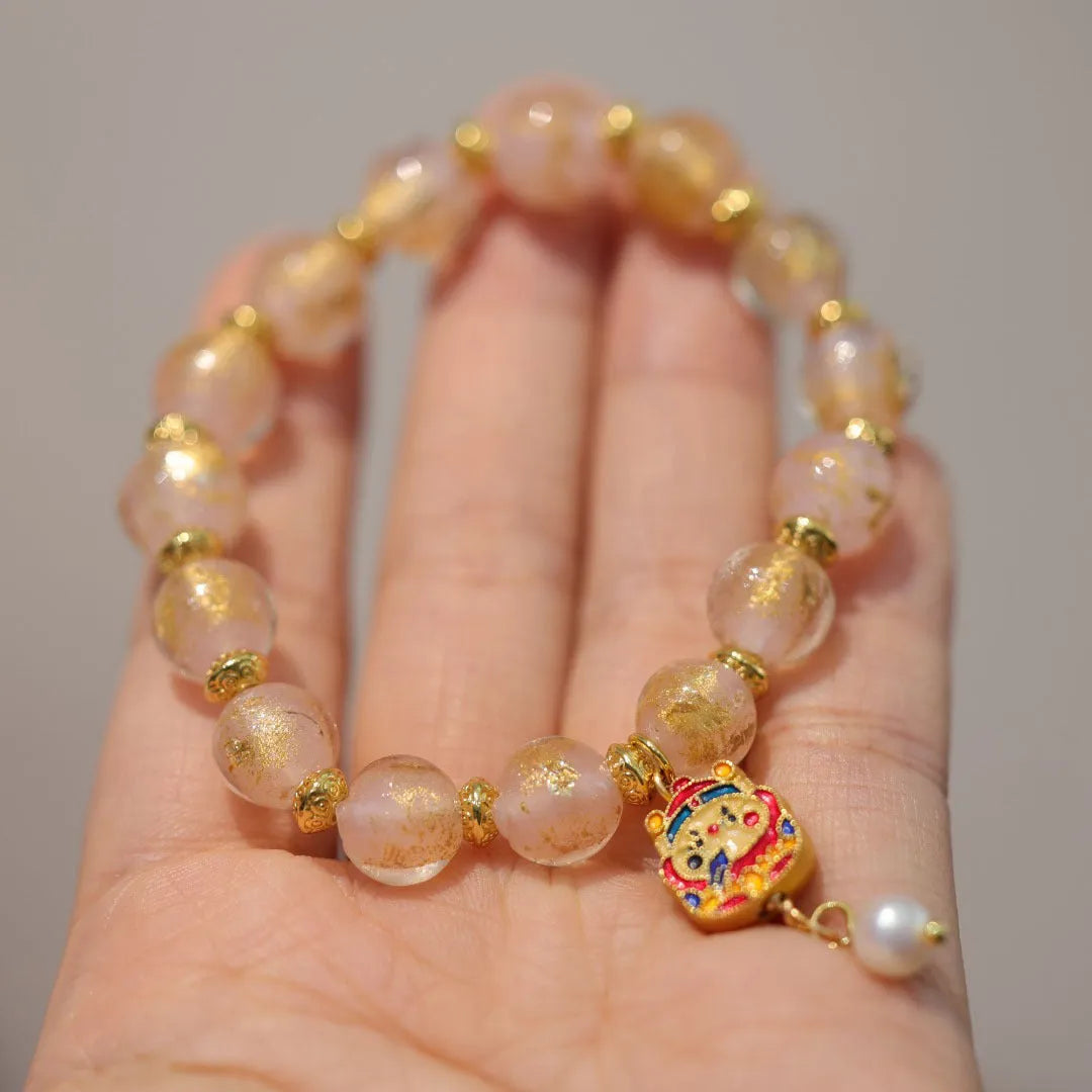 Women's geometric ethnic style bracelet with gold foil coloured glaze and manual glass construction