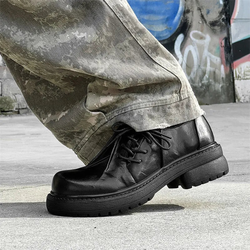 Black platform leather-style shoes with round toe and low top for height increase.