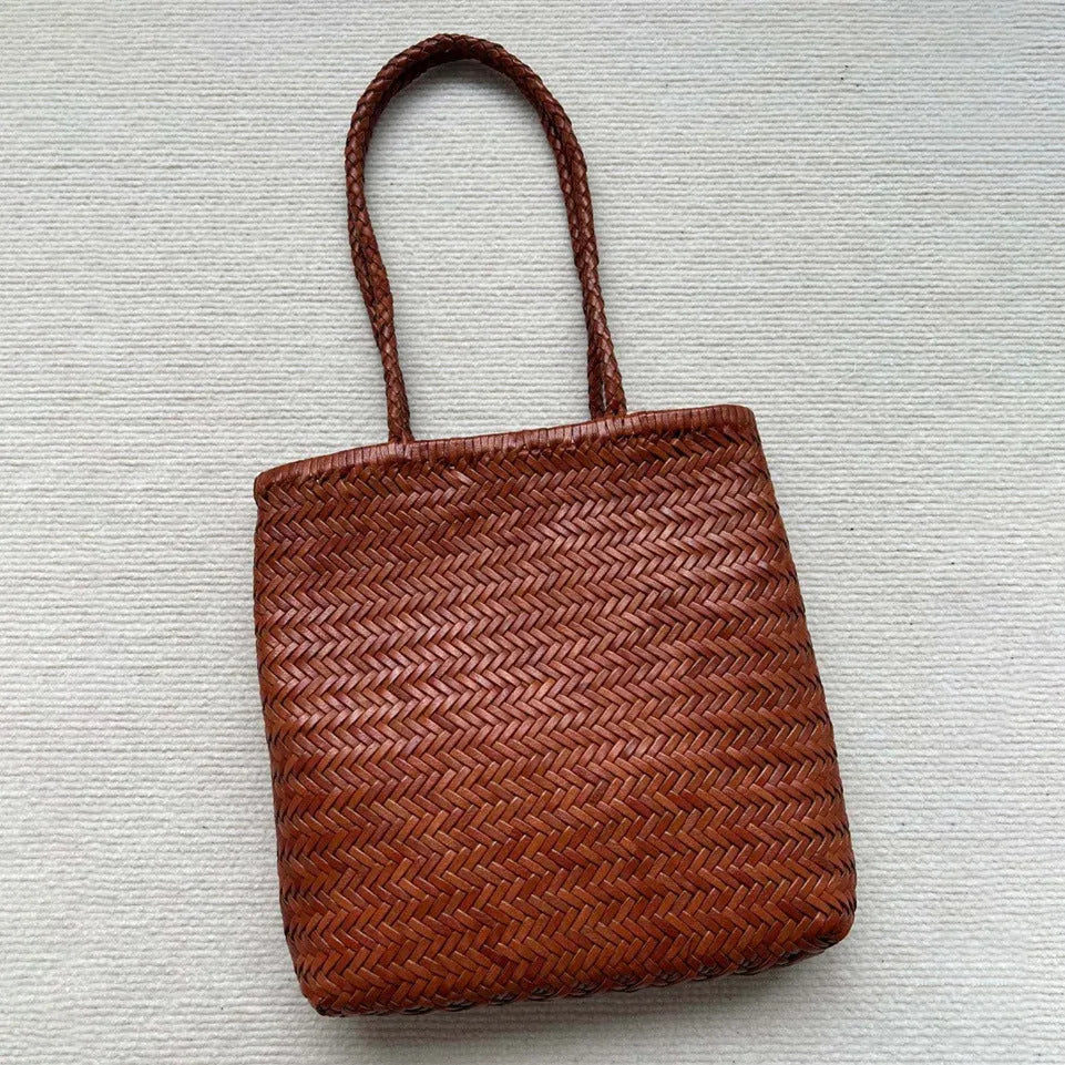 Handmade brown woven cowhide leather tote bag with a structured front pocket.