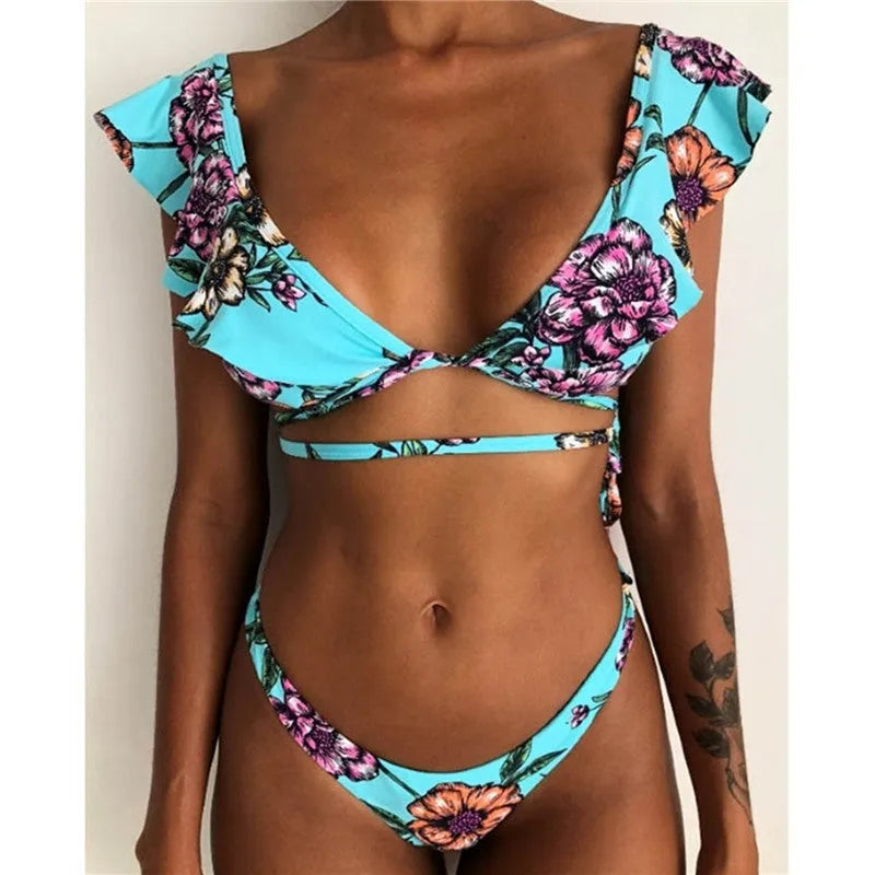 Yellow floral print split bikini swimsuit set with top and pants on a mannequin