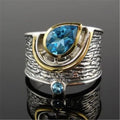 Close-up of a women's blue zircon rhinestone ring in a creative Chinese style drop shape design.