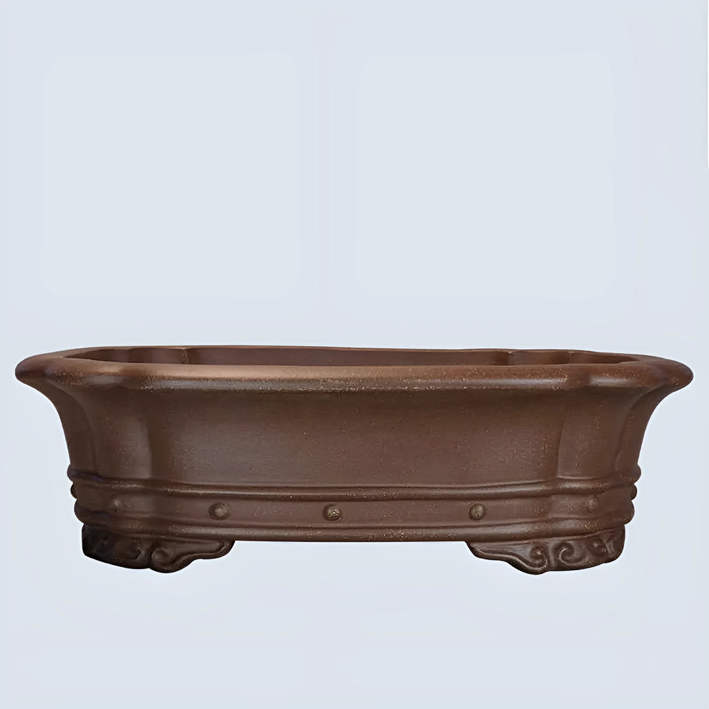 Purple sand handmade antique rectangular begonia flower pot on a desktop.