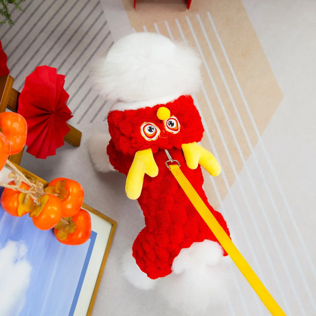 Red fluffy pet jacket with cartoon dragon design on a dog, showing velvet texture and fit.
