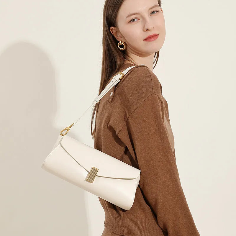 Beige cowhide leather women's cross-body bag with clamshell opening showing internal organisation pockets