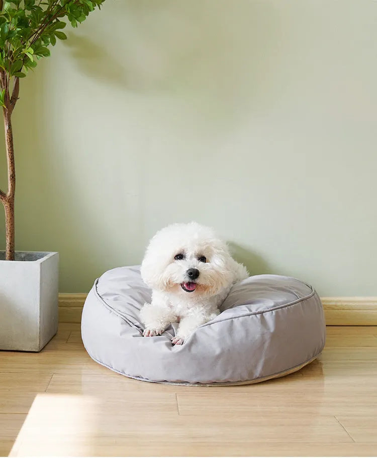 Round plush pet bed for small and medium dogs and cats, 60-80cm diameter, beige or grey, with raised rim.