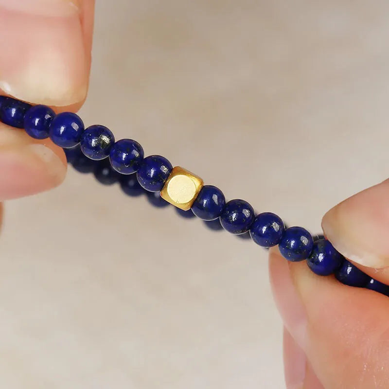 Close-up of a women's bracelet with a large 16mm geometric green gold stone crystal bead.