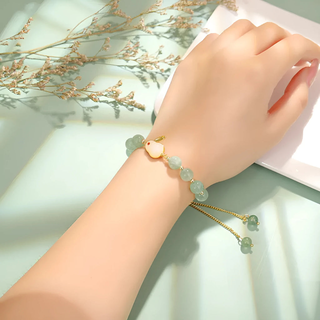 Women's rabbit design bracelet with green natural stones and copper gold accents