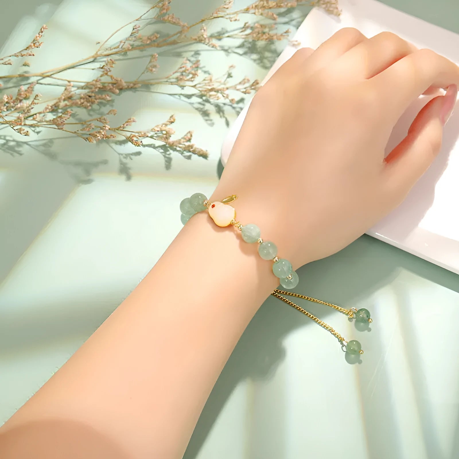 Women's rabbit design bracelet with green natural stones and copper gold accents