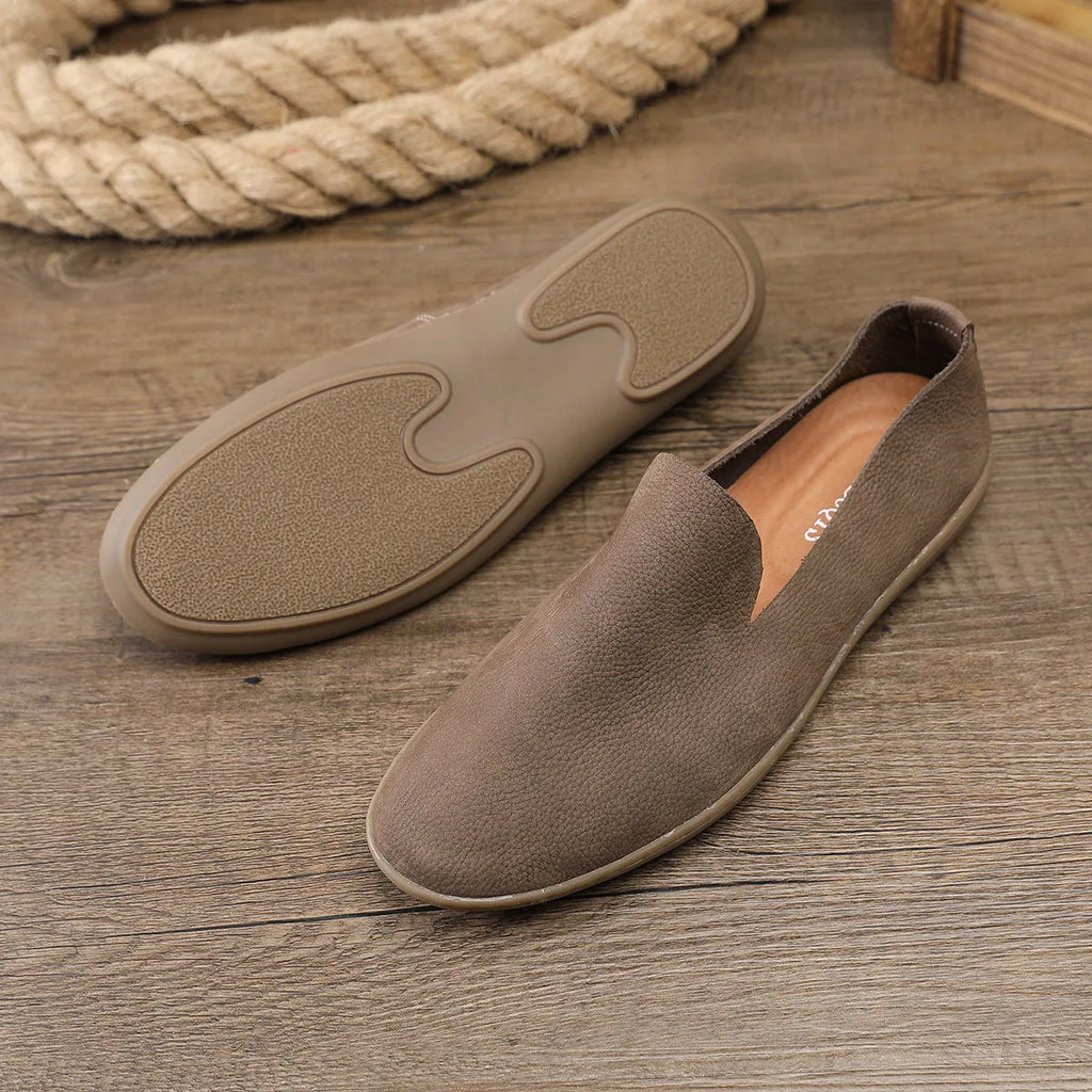 Handmade low top men's shoes in khaki or grey with a flat wedge heel and rubber sole.