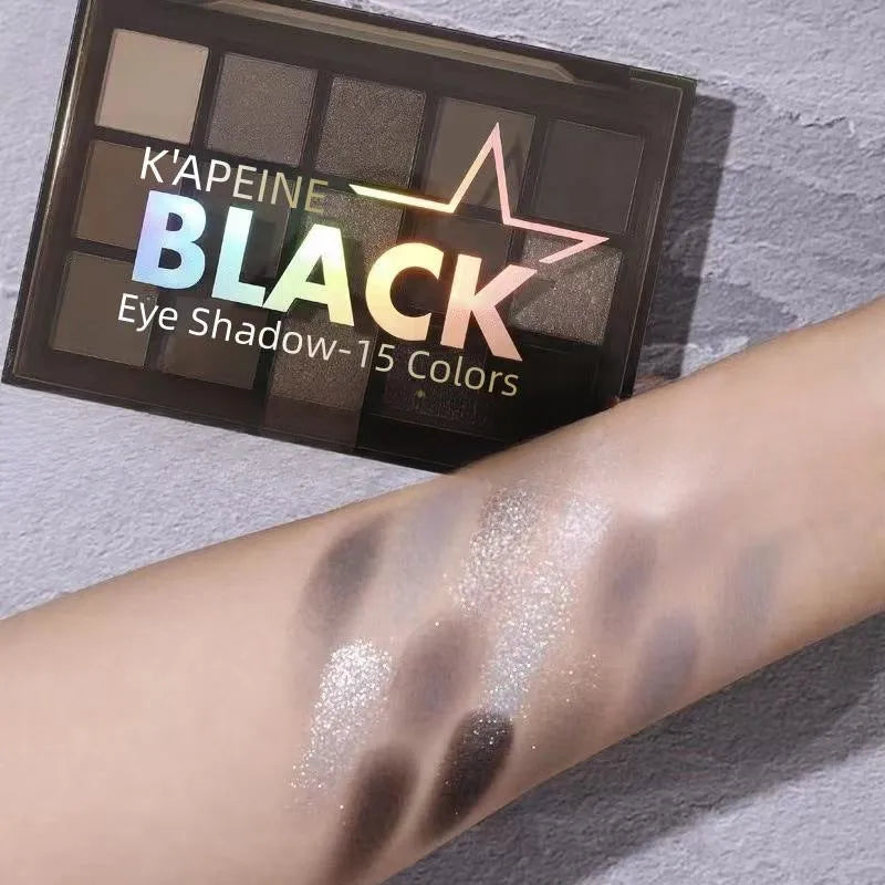 15-colour eyeshadow palette showing matte and shimmer pans including grey-black smokey shades