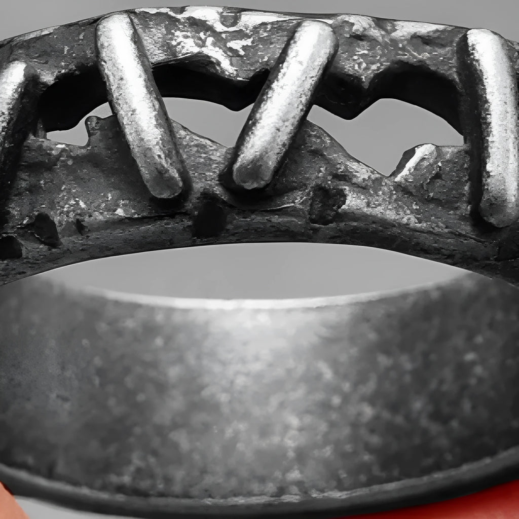 Close-up of a stainless steel double ring with dark punk stitching style, shown on a finger.