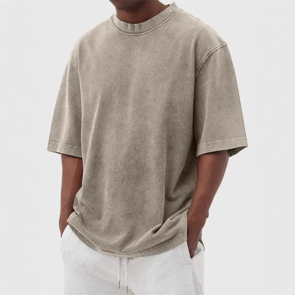 Man wearing a loose-fit, distressed army green pullover T-shirt with half sleeves.