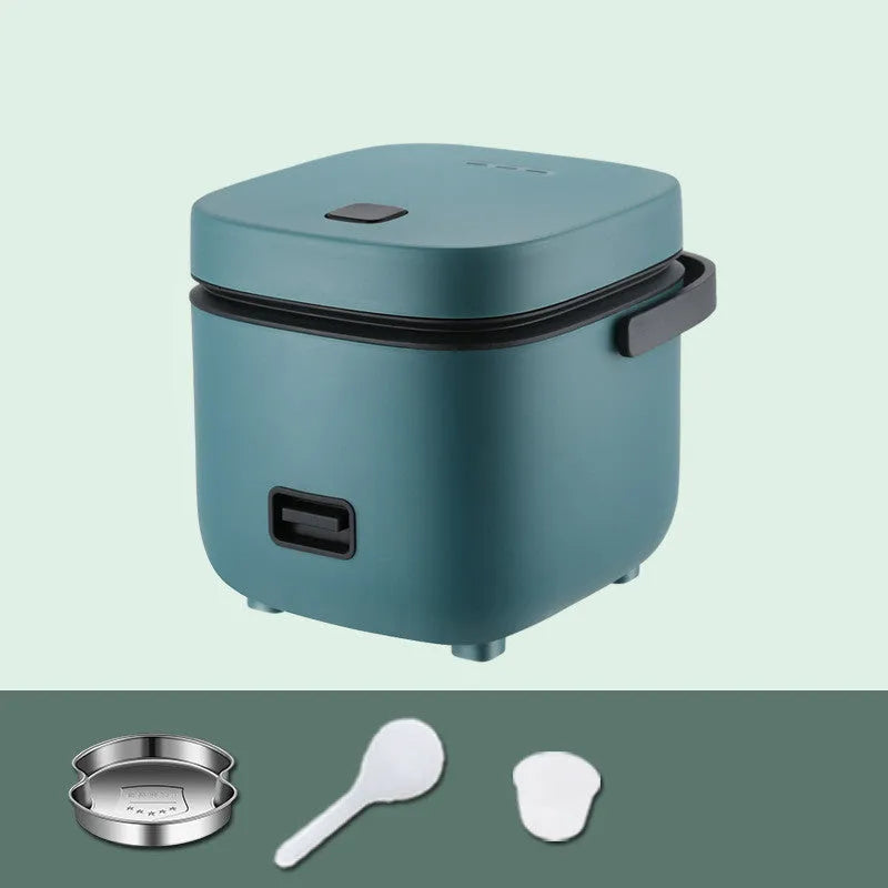 Green 1.2L mini rice cooker with metal body, button controls, and steaming plate on a worktop.