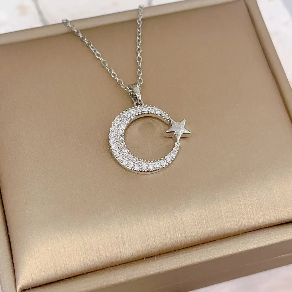 Xingyue gold geometric moon pendant necklace with zircon stone on titanium steel O-ring chain against white background