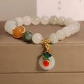 Close-up of a women's ice jade bracelet with carved Xiangyun design, pearl accents, and a jade sliding buckle.