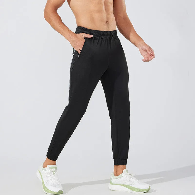 Men's black polyester running trousers with mid-waist, shown flat.