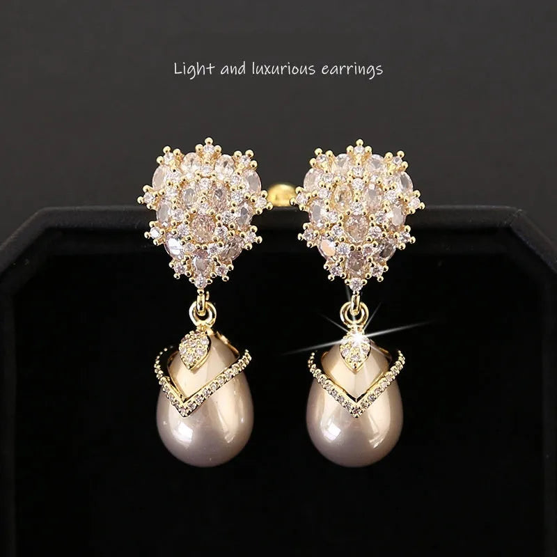 Drop-shaped women's pearl earrings with zircon stones in copper 18K setting