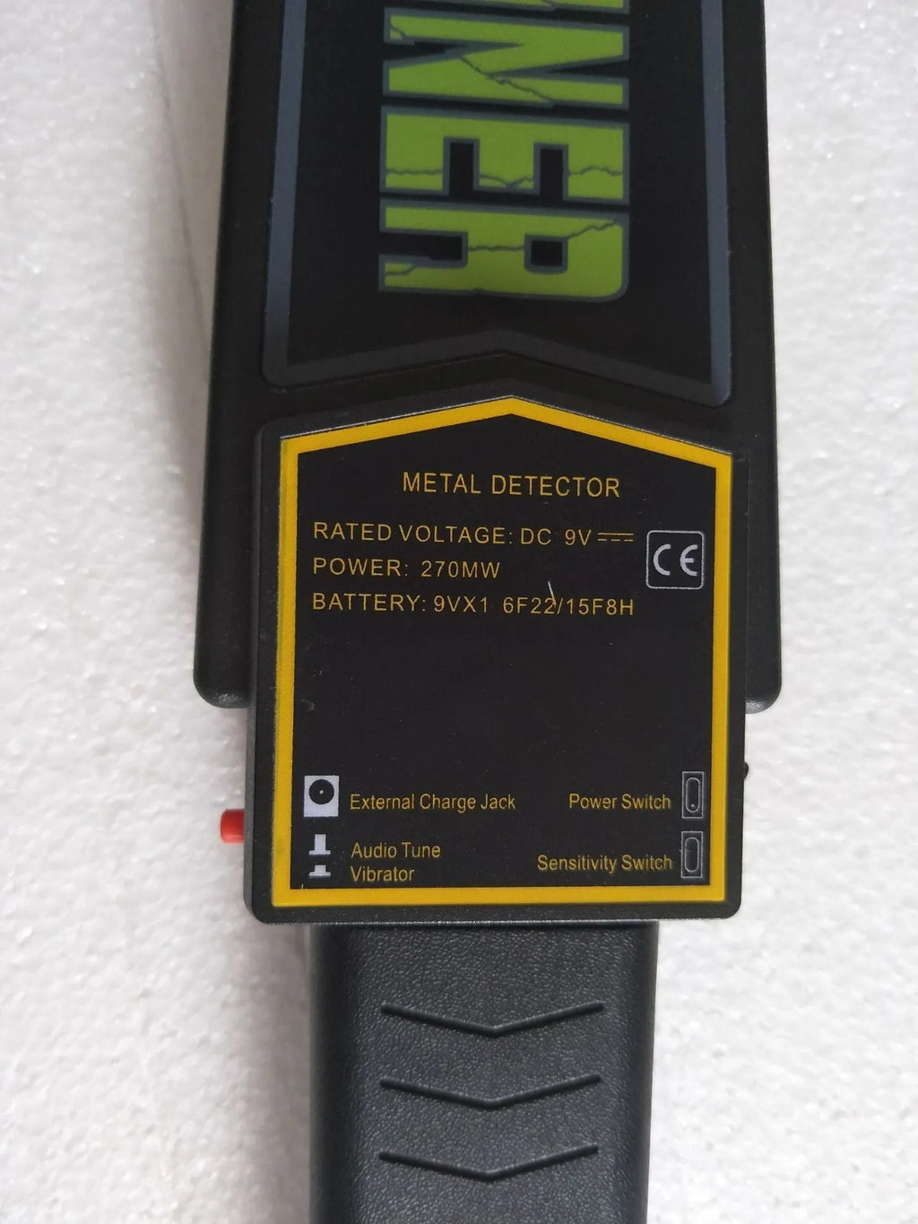 Black handheld metal detector with leather carrying case, 410mm length, for security screening