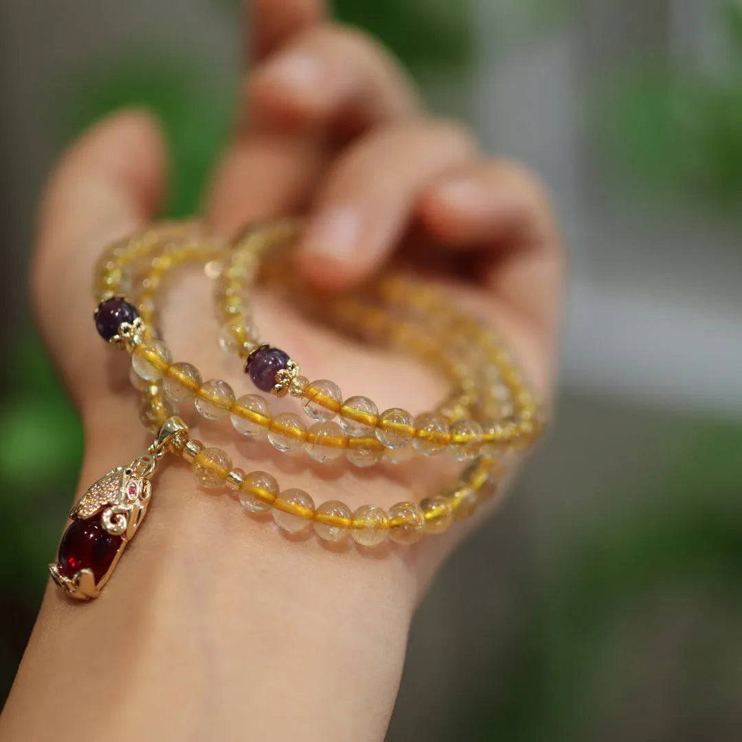 Natural Brazilian gold rutilated quartz bracelet with three gold beads and hanging chopsticks ornament