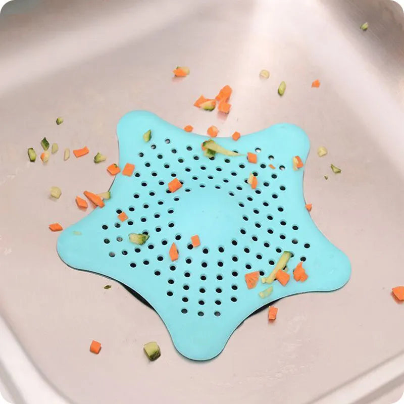 Three silicone starfish-shaped sink drain filters in white blue and green with suction cups