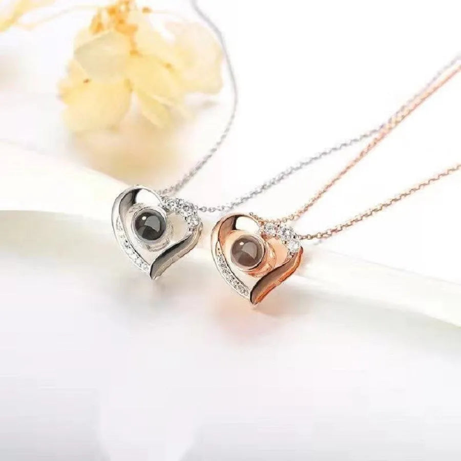 Geometric copper projection necklace with diamond inlay, rose gold finish, cross chain style on collarbone